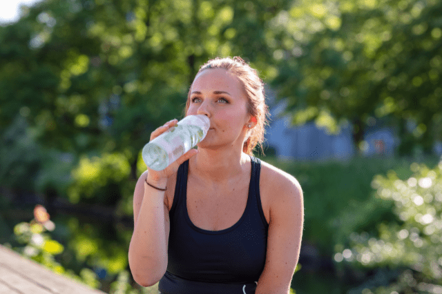 woman drinking cucumber water